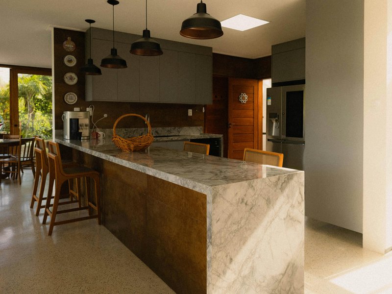Kitchen renovation showcasing new vinyl or hardwood flooring with cabinets and countertops in a bright modern home